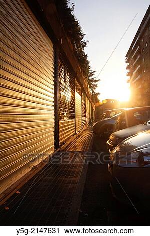 Row of Closed shutters on shop fronts at sunset in rome italy View Large Photo Image Stock Image - Row of Closed shutters on shop fronts at sunset in rome italy. Fotosearch
