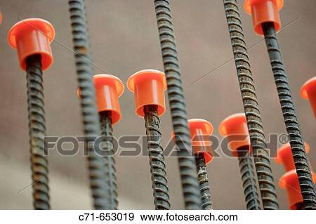 row of construction steel rebar with protective plastic caps View Large Photo Image Stock Photo - row of construction steel rebar with protective plastic caps. Fotosearch