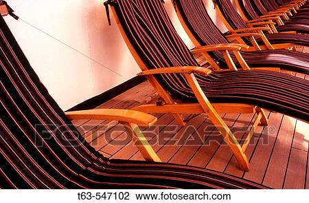 Stock Image - row of deck chairs on cruise ship. Fotosearch