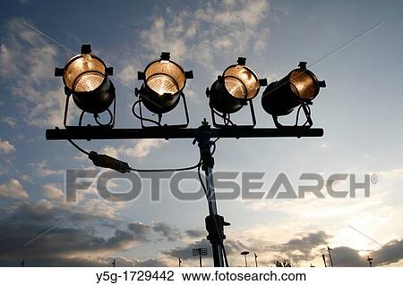 Stock Image - row of studio type spot lights outdoors. Fotosearch