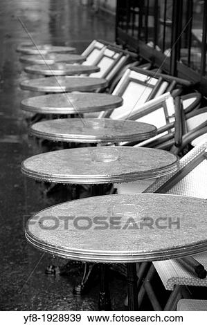 Row of wet round tables cafe terrace in Quay Branly Paris France View Large Photo Image Stock Photo - Row of wet round tables cafe terrace in Quay Branly Paris France. Fotosearch