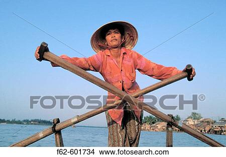 Rower in traditional riverboat. Cantho. Vietnam View Large Photo Image Picture - Rower in traditional riverboat. Cantho. Vietnam. Fotosearch