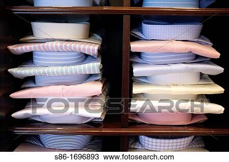 Stock Image - Rows of Men's Dress Shirts Displayed in a Retail Store. Fotosearch