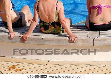 Royal caribbean cruise line. Grandeur of the Seas. Pool deck. Women sitting by the pool. View Large Photo Image Stock Image - Royal caribbean cruise line. Grandeur of the Seas. Pool deck. Women sitting by the pool.. Fotosearch