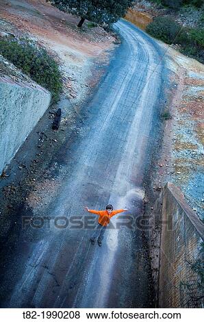 Runaway overhead view of child with arms outstretched abandoned road playing, Berrocal, Huelva, Andalucia, Spain View Large Photo Image Stock Photo - Runaway overhead view of child with arms outstretched abandoned road playing, Berrocal, Huelva, Andalucia, Spain. Fotosearch