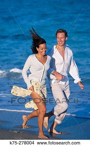 Picture - running along the seashore. Fotosearch