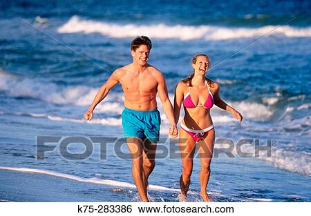 Running along the shore View Large Photo Image Stock Photograph - Running along the shore. Fotosearch