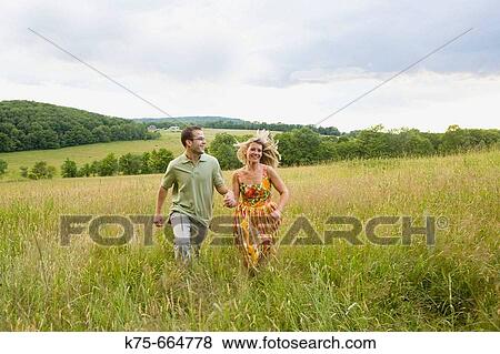 Running on top of hill in field View Large Photo Image Stock Photo - Running on top of hill in field. Fotosearch