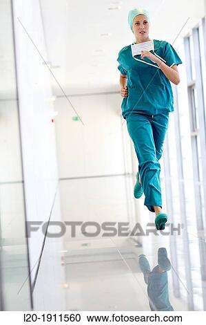 Stock Image - running surgeon in the operating room hallway, Onkologikoa Hospital, Oncology Institute, Case Center for prevention, diagnosis and treatment of cancer, Donostia, San Sebastian, Gipuzkoa, Basque Country, Spain. Fotosearch