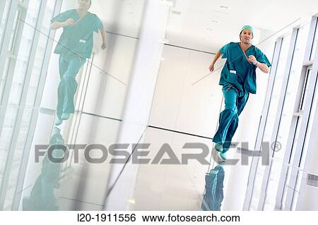 Stock Photograph - running surgeon in the operating room hallway, Onkologikoa Hospital, Oncology Institute, Case Center for prevention, diagnosis and treatment of cancer, Donostia, San Sebastian, Gipuzkoa, Basque Country, Spain. Fotosearch