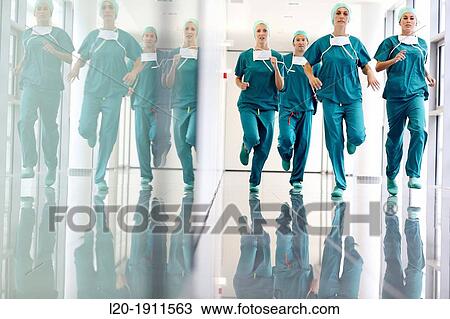 Stock Image - running surgeons in the operating room hallway, Onkologikoa Hospital, Oncology Institute, Case Center for prevention, diagnosis and treatment of cancer, Donostia, San Sebastian, Gipuzkoa, Basque Country, Spain. Fotosearch