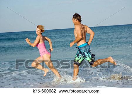 Running through the surf View Large Photo Image Stock Image - Running through the surf. Fotosearch