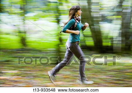 Running young woman in forest, panning photo View Large Photo Image Stock Photo - Running young woman in forest, panning photo. Fotosearch