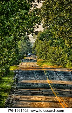 Rural road in Lancaster, NH with car with headlights on approaching, USA View Large Photo Image Stock Image - Rural road in Lancaster, NH with car with headlights on approaching, USA. Fotosearch