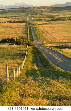 Stock Image - rural road looking south near Pincher Creek, Alberta. Fotosearch