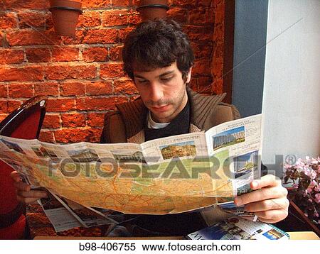 Stock Photography - Russia, Moscow, Abe Nowitz in restuarant, reading map. (MR). Fotosearch