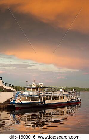Stock Photograph - Russia, Yaroslavl Oblast, Golden Ring, Yaroslavl, Volga Riverfront, riverboat, sunset. Fotosearch