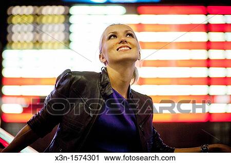 Russian woman in front of illuminated American Flag, Times Square New York at night View Large Photo Image Stock Image - Russian woman in front of illuminated American Flag, Times Square New York at night. Fotosearch