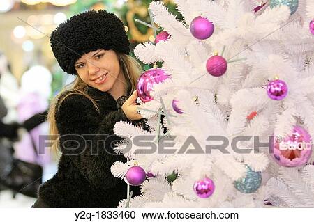 Stock Image - Russian woman with a christmas tree, Moscow, Russia. Fotosearch