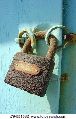 Stock Image - Rusted lock on turquoise door in Santorini, Greece. Fotosearch
