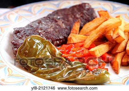 Rustic grilled beefsteak with french fries and peppers Spain. View Large Photo Image Stock Photograph - Rustic grilled beefsteak with french fries and peppers Spain.. Fotosearch