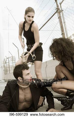 Stock Photo - Ryan, Kelly, Alli with gun rope and lipstick. Fotosearch