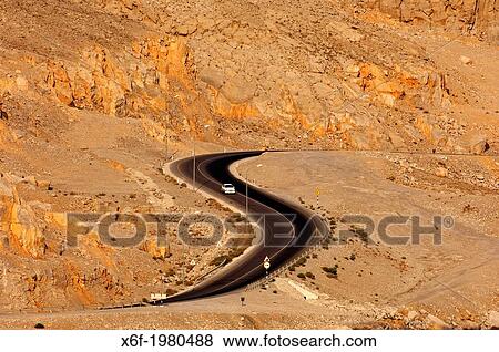 Stock Photo - S-shaped segment of the road to Khasab meandering in barren mountain ranges, Musandam, Sultanate of Oman.. Fotosearch