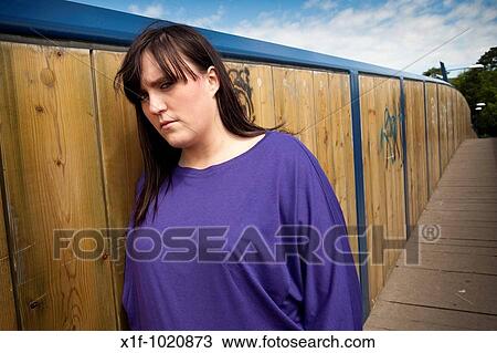 Sad depressed young overweight woman standing on walkway bridge View Large Photo Image Stock Image - Sad depressed young overweight woman standing on walkway bridge. Fotosearch