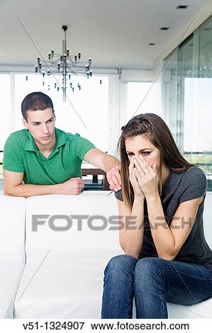 Sad woman in sofa and boyfriend trying to support her View Large Photo Image Stock Photo - Sad woman in sofa and boyfriend trying to support her. Fotosearch