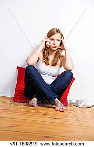 Sad woman on the phone at home View Large Photo Image Stock Photo - Sad woman on the phone at home. Fotosearch