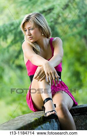 Picture - Sad young woman in a short Violet dress. Fotosearch