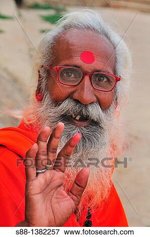 Stock Photo - Sadhu at the ghat by the Ganges River. Fotosearch