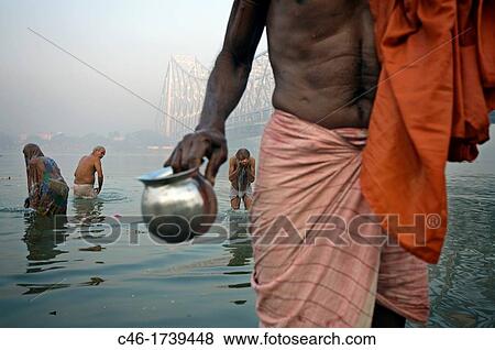 Stock Photo - Sadhu by the Howrah Bridge, Hooghly River, Kolkata, India, Ganges River.. Fotosearch