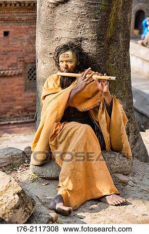 Sadhu playing his flute, Kathmandu, Nepal. View Large Photo Image Stock Photo - Sadhu playing his flute, Kathmandu, Nepal.. Fotosearch