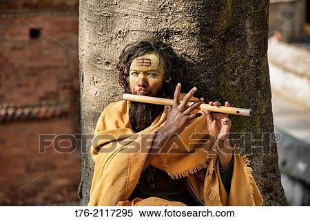 Stock Photography - Sadhu playing his flute, Kathmandu, Nepal.. Fotosearch