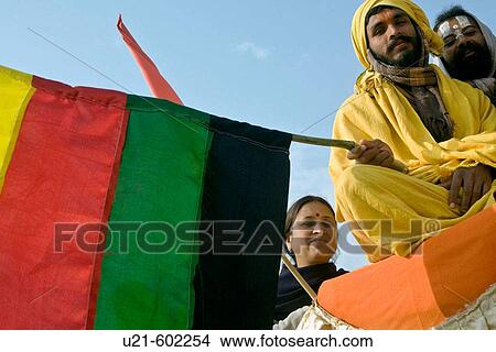 Picture - Sadhus and pilgrims on top of a truck during the procession during the Ardh Khumbh Mela... Fotosearch