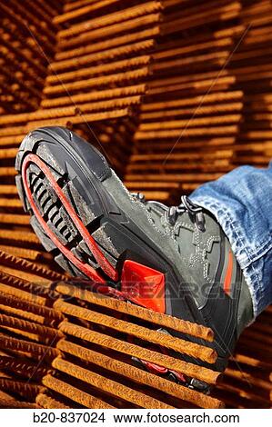 Safety boot, corrugated iron for formwork, housing construction View Large Photo Image Picture - Safety boot, corrugated iron for formwork, housing construction. Fotosearch