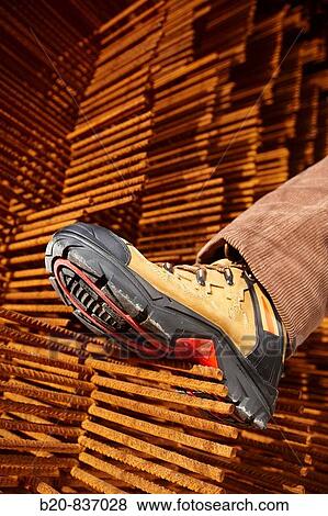 Safety boot, corrugated iron for formwork, housing construction View Large Photo Image Stock Photo - Safety boot, corrugated iron for formwork, housing construction. Fotosearch
