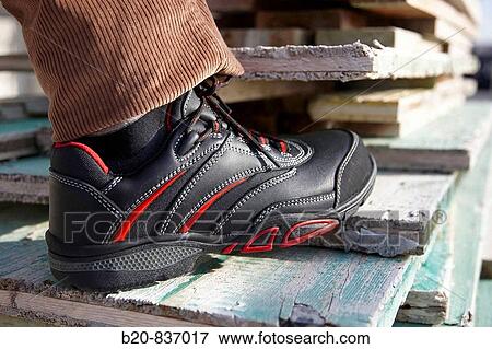 Safety boots, housing construction, plank moulds View Large Photo Image Stock Photo - Safety boots, housing construction, plank moulds. Fotosearch