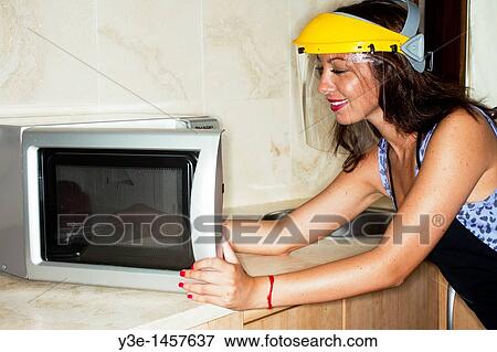 Safety Woman in kitchen Faceshield/microwave View Large Photo Image Stock Photo - Safety Woman in kitchen Faceshield/microwave. Fotosearch