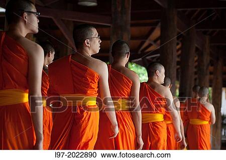 Saffron robbed monks leave morning prayers near the Wat Pak Nam temple, Bangkok Thailand. View Large Photo Image Stock Image - Saffron robbed monks leave morning prayers near the Wat Pak Nam temple, Bangkok Thailand.. Fotosearch