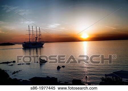 Stock Photography - Sail Boat at Sunset. Old Town Harbor, Little Venice, Mykonos, Greece Greek Islands.. Fotosearch