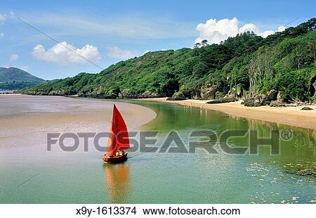 Sailboat dinghy at White Sands Bay on the Portmeirion estate near Porthmadog, Gwynedd north Wales, UK West across Tremadog Bay View Large Photo Image Picture - Sailboat dinghy at White Sands Bay on the Portmeirion estate near Porthmadog, Gwynedd north Wales, UK West across Tremadog Bay. Fotosearch
