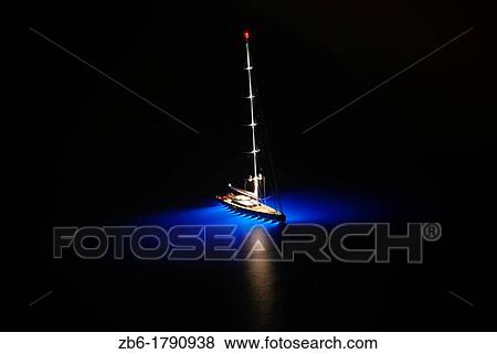 Stock Photo - Sailboat sailing in the Aegean Sea Santorini Greece. Fotosearch