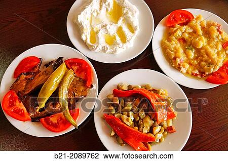 Stock Image - Salads: fried eggplants, yogurt and cucumber, vegetable mixed, and eggplant salad, Turkey. Fotosearch