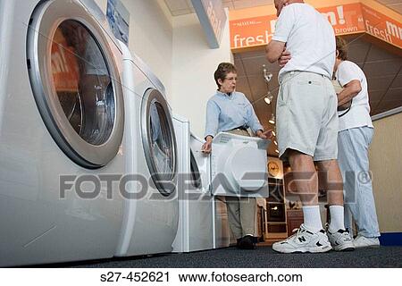 Salesperson Joy Hermann, center, talks about the Maytag dryer to shoppers Veronica and Richard Lanzon of Kirkwood. Missouri. USA. View Large Photo Image Stock Image - Salesperson Joy Hermann, center, talks about the Maytag dryer to shoppers Veronica and Richard Lanzon of Kirkwood. Missouri. USA.. Fotosearch