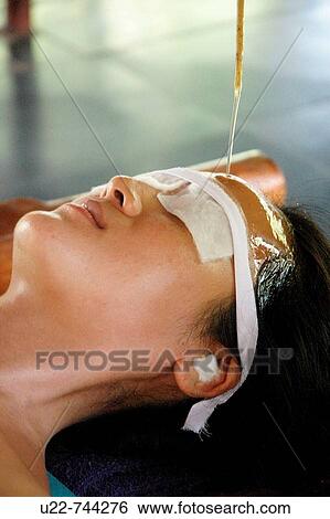 Saligao Goa, India, a woman receiving an ayurvedic massage with oil at the Ayurvedic Natural Health Centre View Large Photo Image Stock Photograph - Saligao Goa, India, a woman receiving an ayurvedic massage with oil at the Ayurvedic Natural Health Centre. Fotosearch