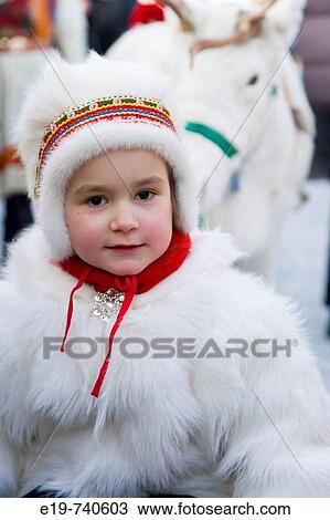 Stock Image - Sami (Lapp) girl in traditional clothes at Winter Fair. Jokkmokk, Northern Sweden. Fotosearch