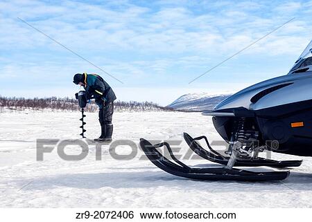 Sami man drilling a hole in ice for ice-fishing in arctic Sweden. View Large Photo Image Stock Photograph - Sami man drilling a hole in ice for ice-fishing in arctic Sweden.. Fotosearch
