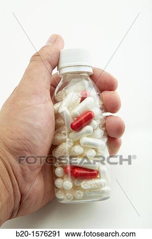 Stock Image - Sample different colored capsules filled with powder and pellets, Generic drugs, Pharmaceutical plant, Drug manufacturing plant, Research Center, Pharmacy, Area Health. Fotosearch